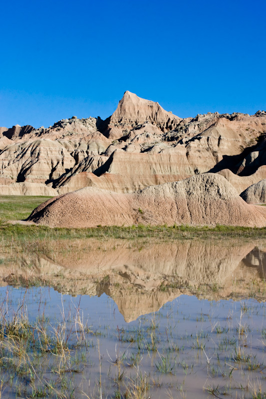 Badlands Reflected In Rainwater Pool